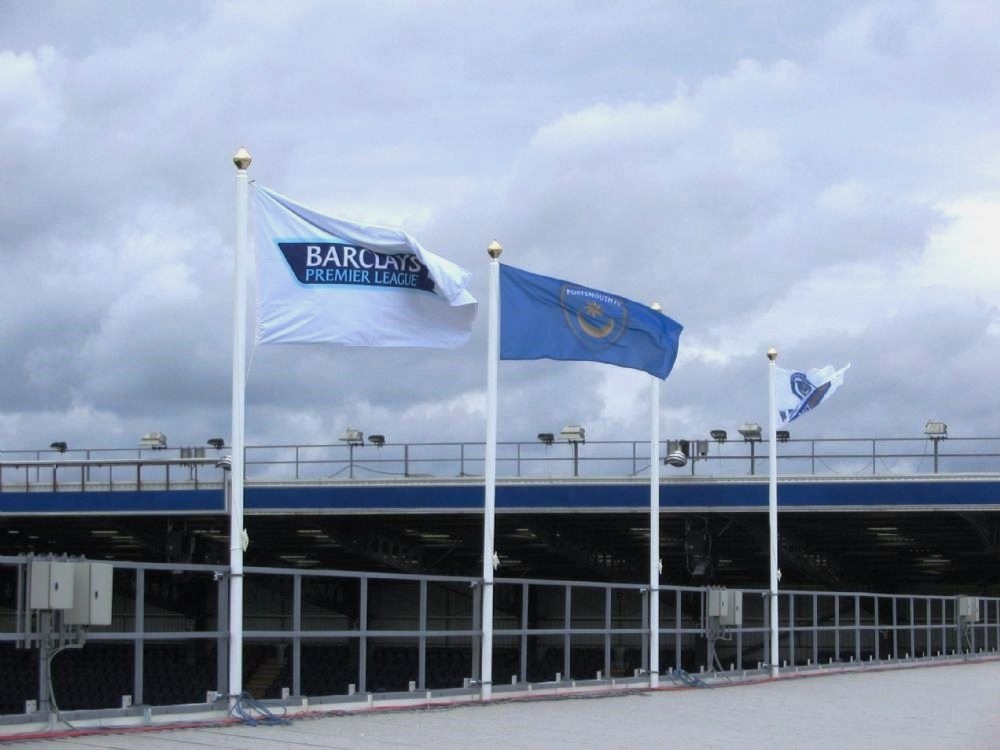 flags and flagpoles on the stadium roof at Portsmouth football club