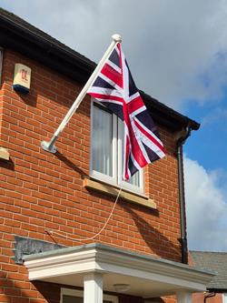 angled flagpole on house with the Union Jack flying  