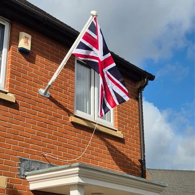 angled aluminium flagpole on a house 