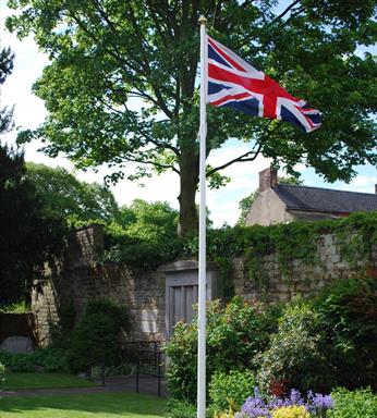 Classic fibreglass flagpole installed outside civic building with Union Jack