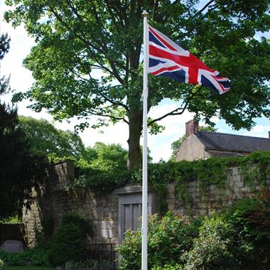 Classic fibreglass flagpole installed outside civic building with Union Jack