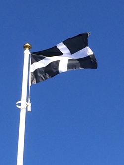 Saint Pirans sewn flag flying from a flagpole