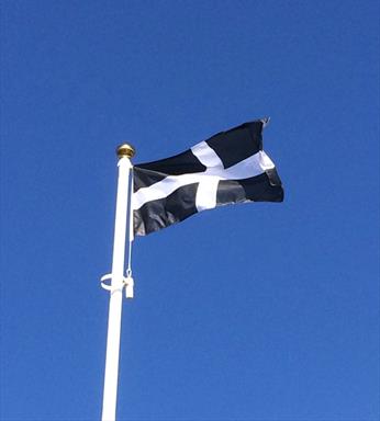 Cornish sewn flag flying from a flagpole