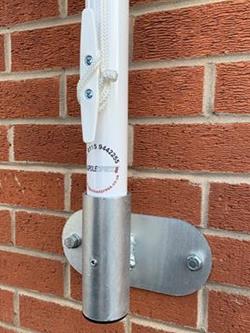 vertical flagpole bracket on a wall