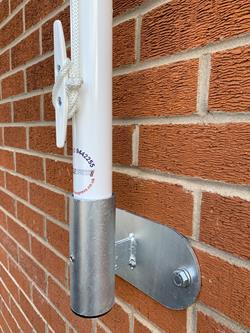 vertical flagpole bracket on a wall