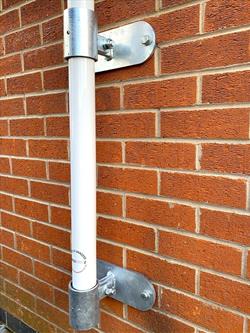 flagpole vertical wall bracket set holding a flagpole