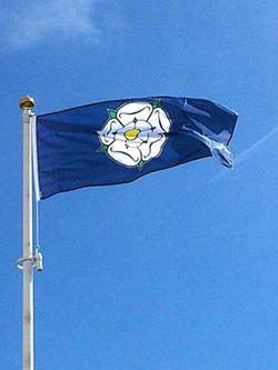Yorkshire rose flag flying on a flagpole 