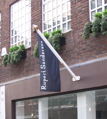 Wall mounted aluminium flag pole with a gold finial