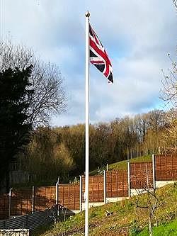 white classic aluminium flagpole flying a union jack flag