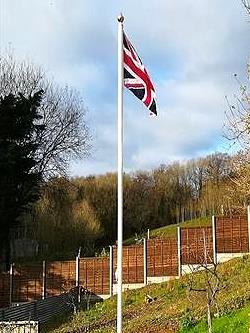 white classic aluminium flagpole flying a union jack flag