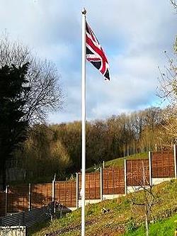 white classic aluminium flagpole flying a union jack flag