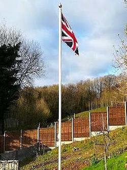 white classic aluminium flagpole flying a union jack flag