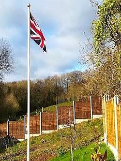 white classic aluminium flagpole flying a union jack flag