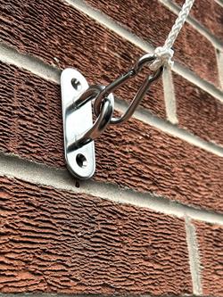 flagpole anti furl bracket fitted to a wall