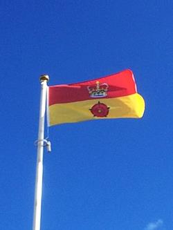 Hampshire county flag flying from a flagpole on a sunny day