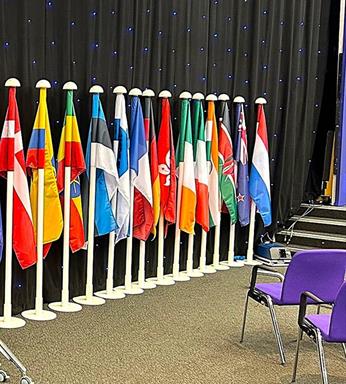 Indoor white aluminium flagpole with weighted steel base for ceremonial displays - Flagpole Express UK