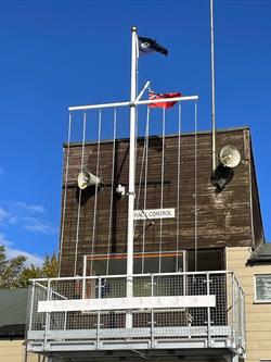 fibreglass flagpole displaying flags from a yard arm