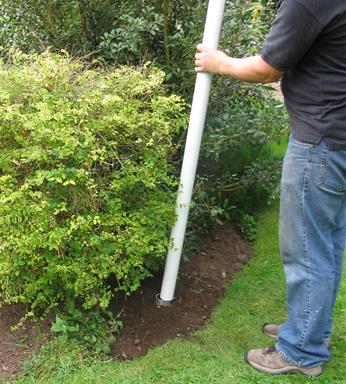 flagpole ground socket in a garden