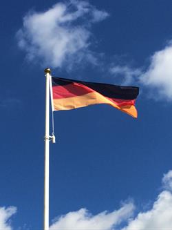 National flag of Germany flying from a flagpole