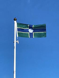 the flag of north yorkshire flying from a flagpole