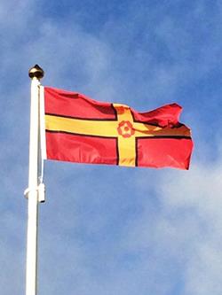 Northamptonshire county flag flying from a white flagpole
