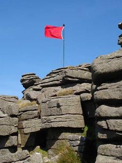 red warning flag flying on flagpole